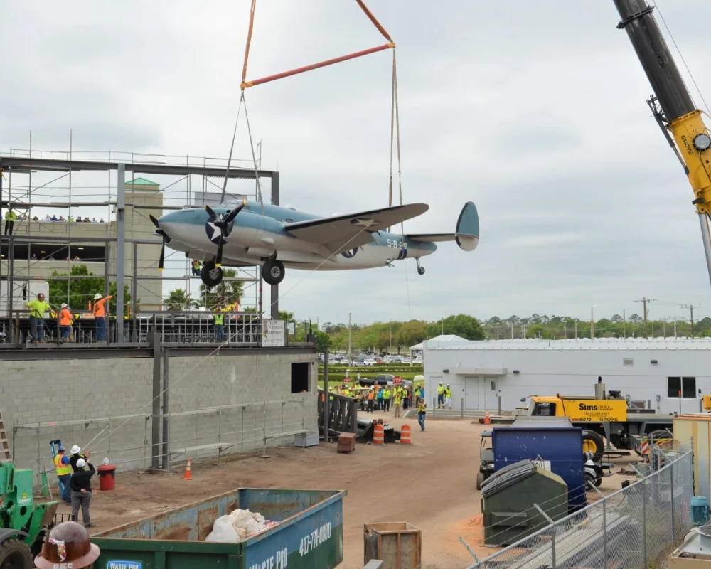 crane placing a model airplane