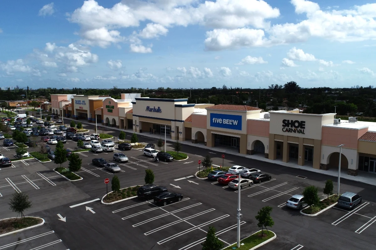 Gardens Promenade aerial view of shopping center store fronts and parking lot