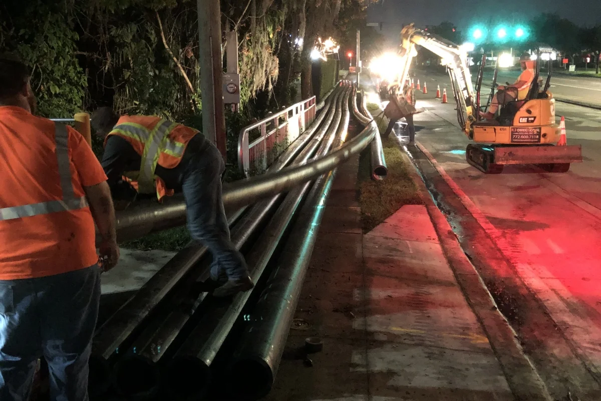 construction team working to lay piping