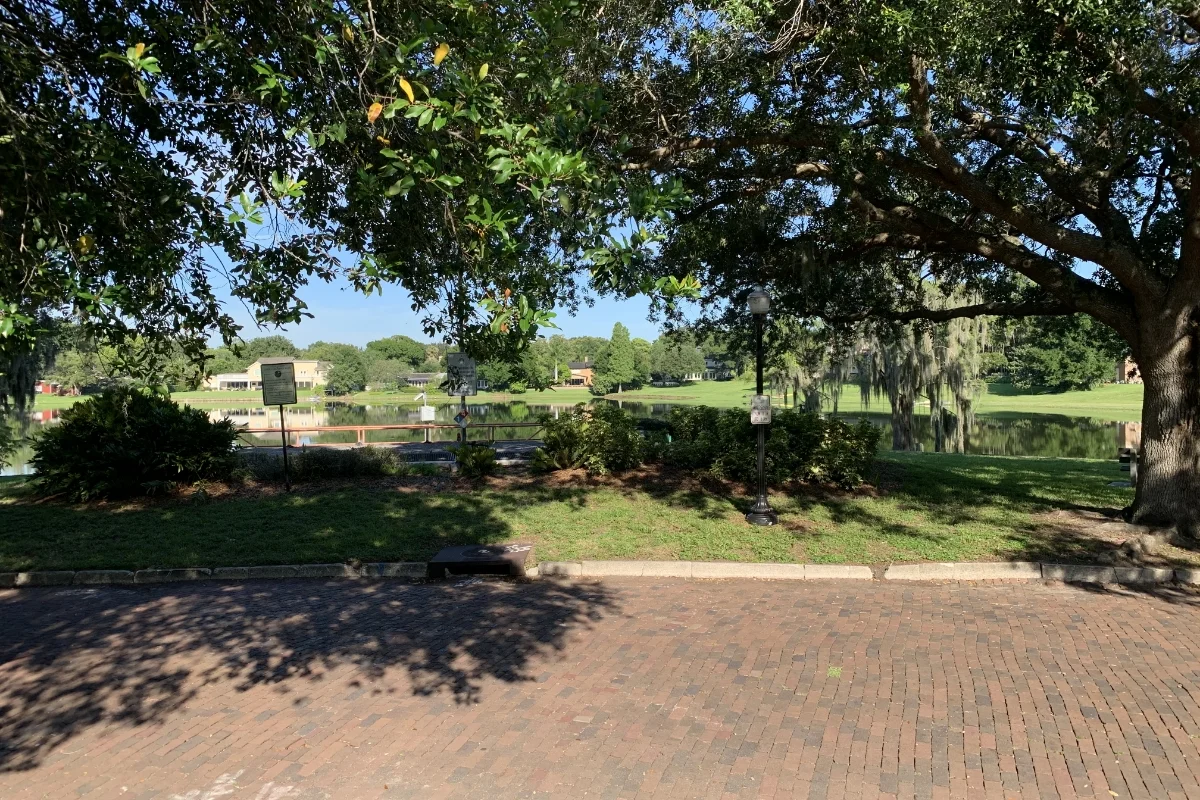 brick sidewalk, grass, and outdoor water pipe