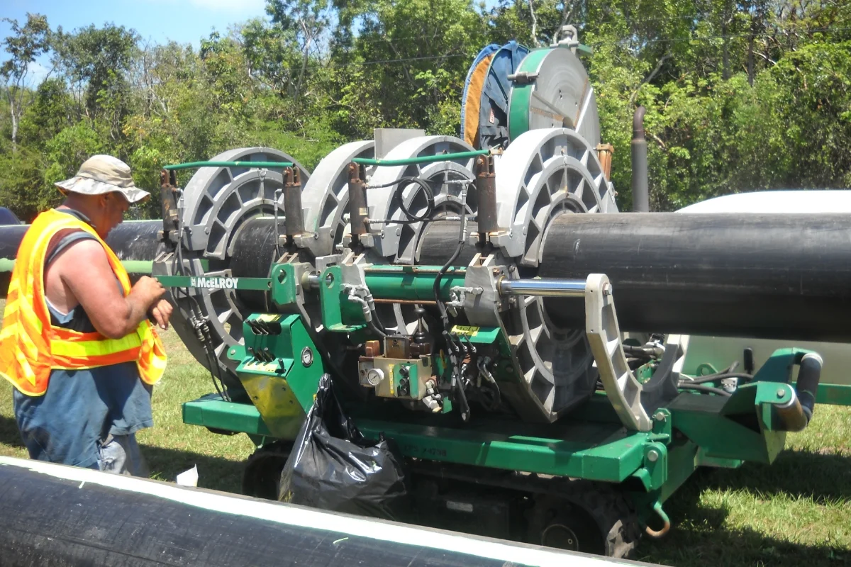 worker in hi-vis with large machinery