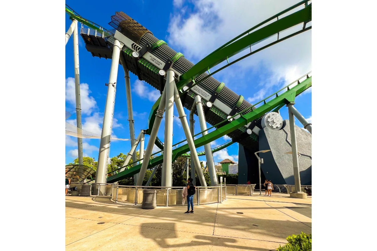 green rollercoaster and sidewalk