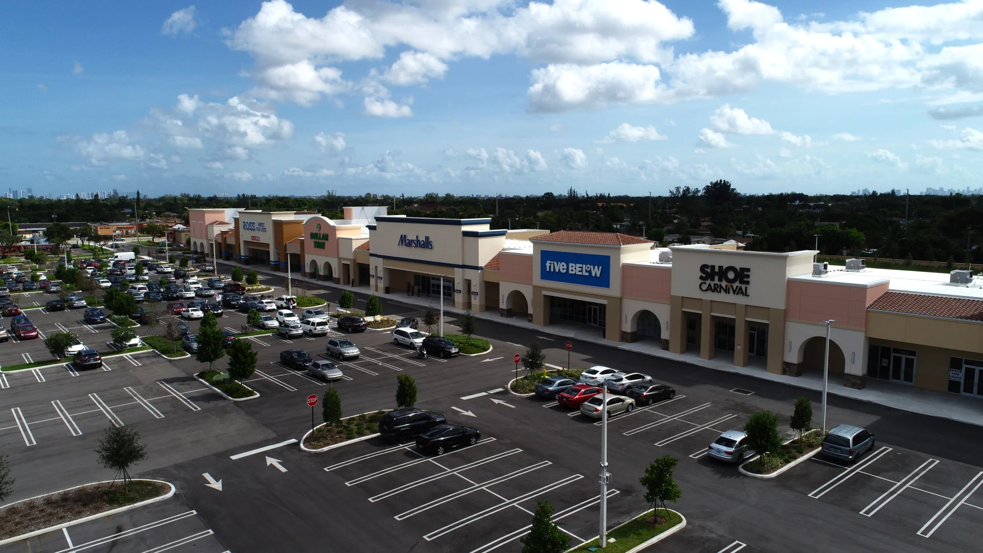 Gardens Promenade aerial view of shopping center store fronts and parking lot