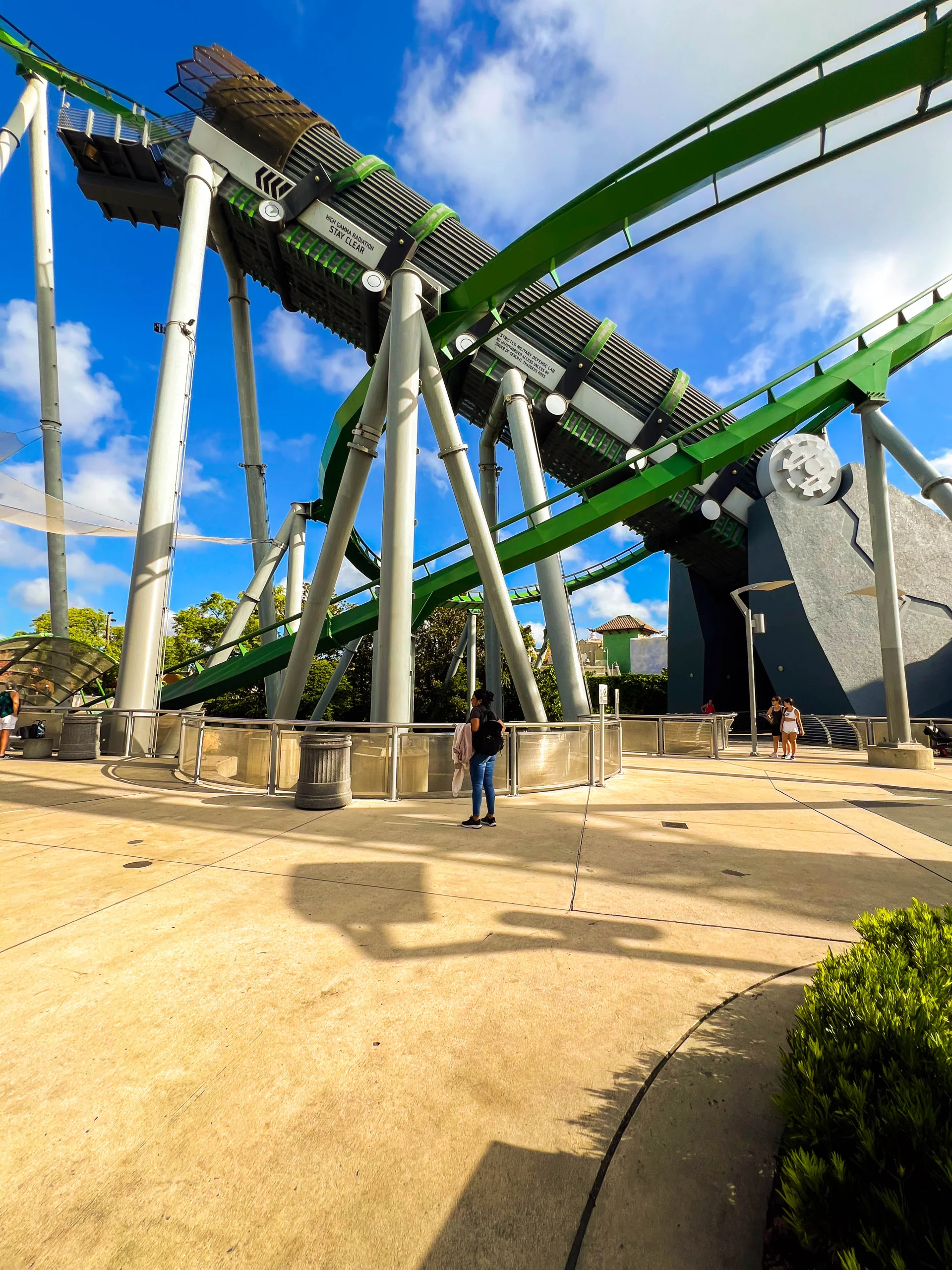 green rollercoaster and sidewalk