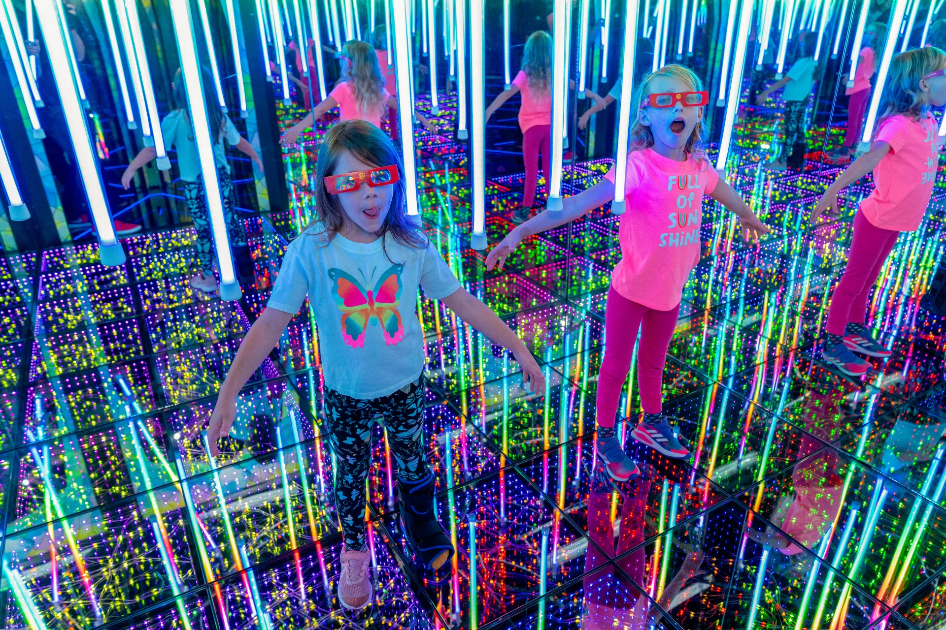 2 children in a mirror maze
