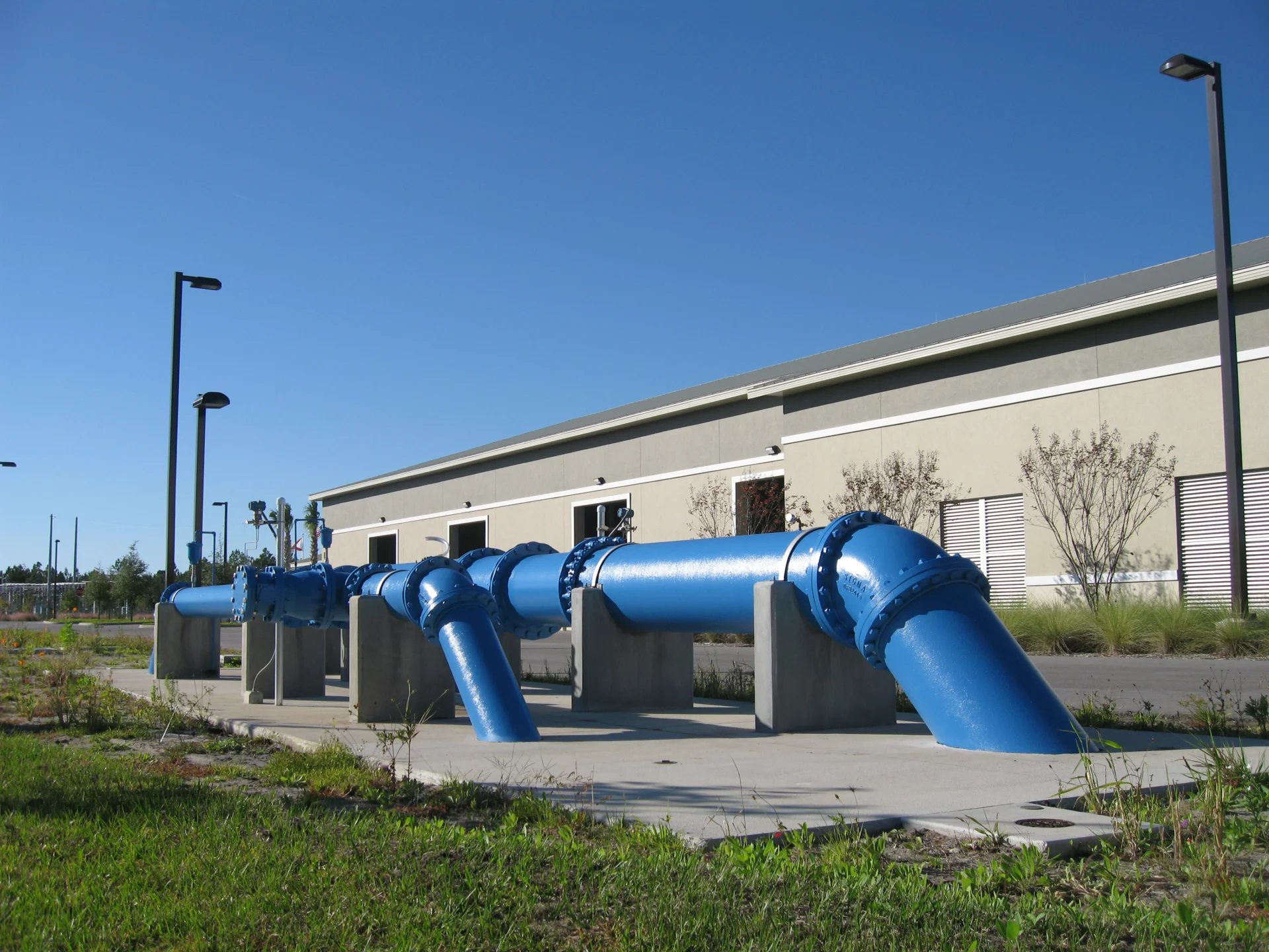 large blue water pipes outside of building